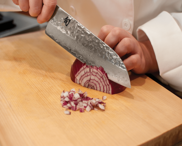 Kai shun knife chopping a red onion
