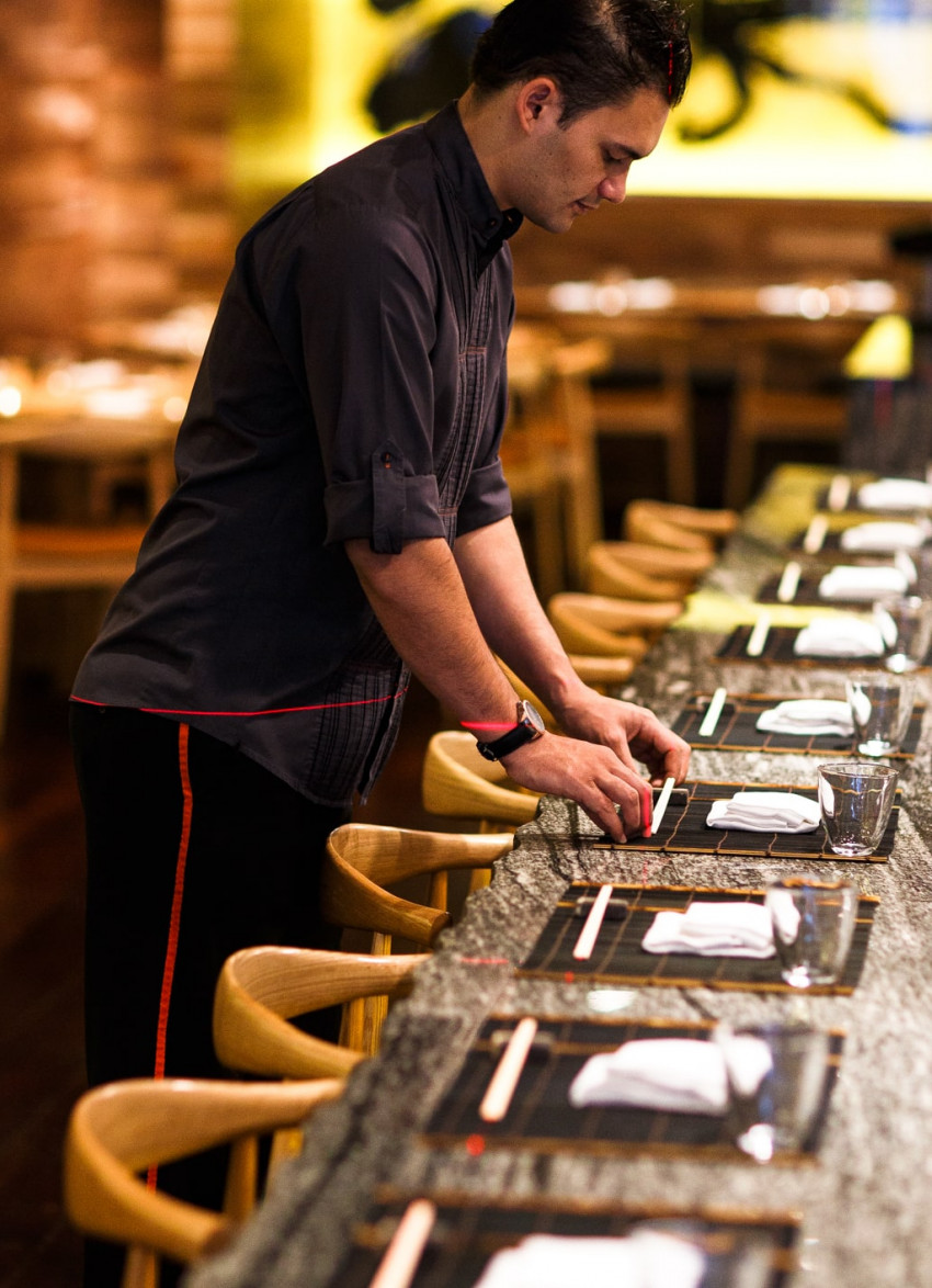 waiter setting table at MASU